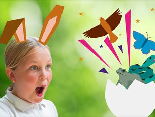 There is a girl wearing a white t-shirt and she has animated bunny ears on her head. She is pointing at an animated egg that has a snake, frog, butter