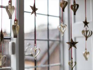 Paper decorations hanging in the window at Jane Austen's House 