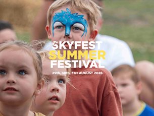 Children in face paintingwatching entertainment at SkyFest Summer at Sky Park Farm in West Harting.