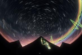 Visuals on a Planetarium dome. There is a mountain in silhouette and a rainbow in the background.