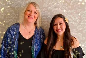 Two female singers with a sparkly background