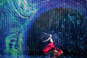 Dancer stands under wave