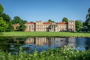 A view of The Vyne house and north lawn from across the lake.