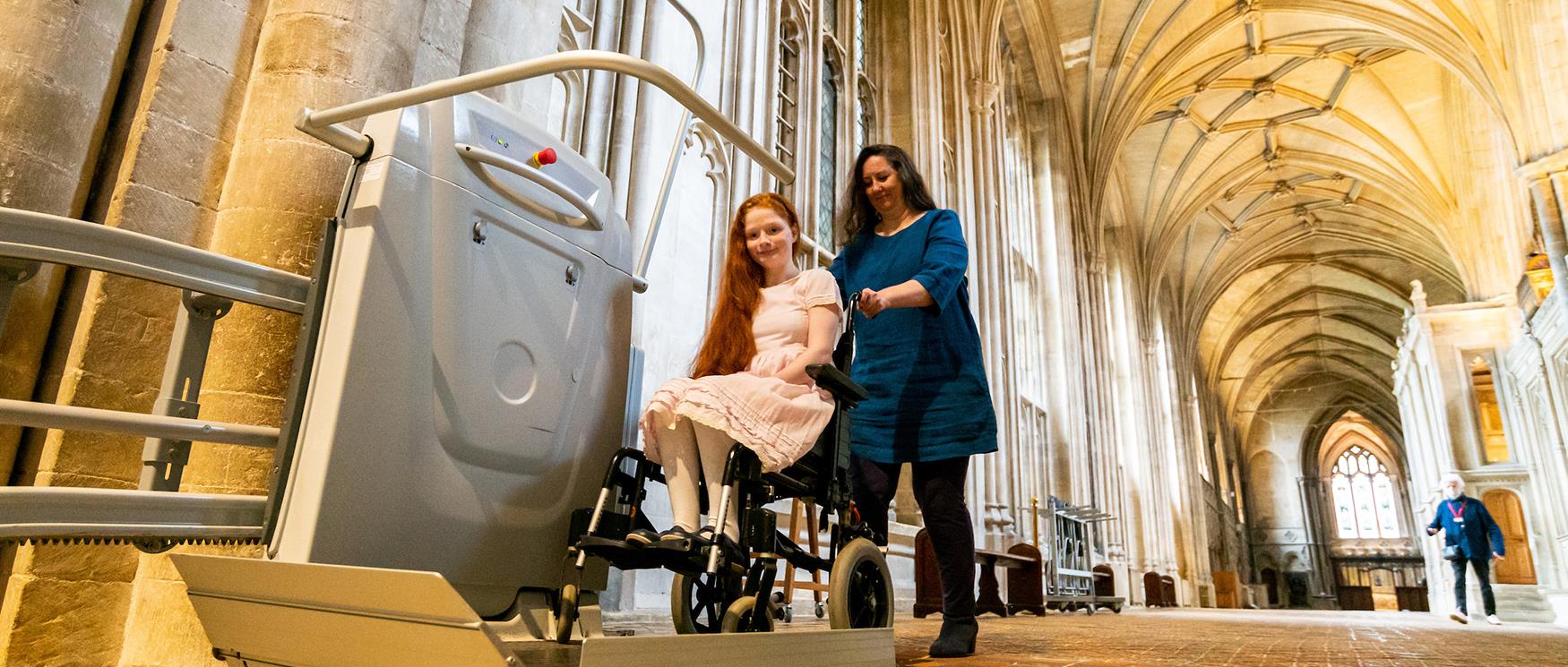 Child in wheelchair with carer at Winchester Cathedral