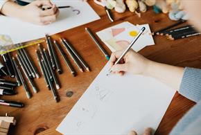 Stock image of people illustrating at an art course