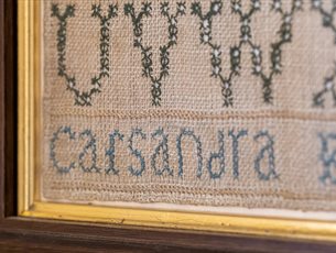 Sewing circle at Jane Austen's House. Sampler by Cassandra Austen at Jane Austen's House.
