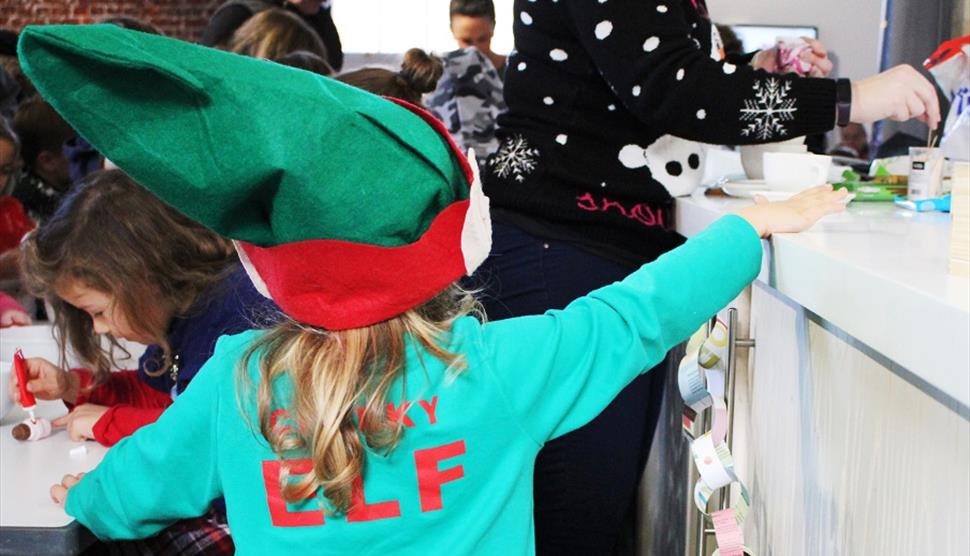 Young girl in a Cheeky Elf costume at the Aspex Portsmouth Festive Family Fun Day