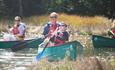 Father and son canoeing down the Beaulieu River with New Forest Activities