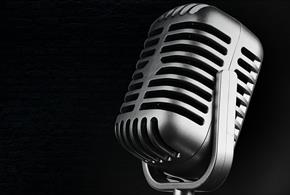 Stock image of a microphone on a black background for the Solent Hotel & Spa's tribute evenings