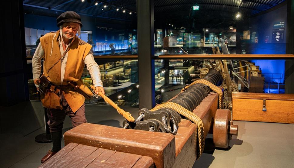 Tudor reenactor with a cannon at the Mary Rose