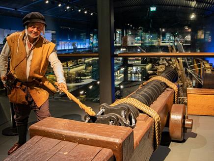 Tudor reenactor with a cannon at the Mary Rose