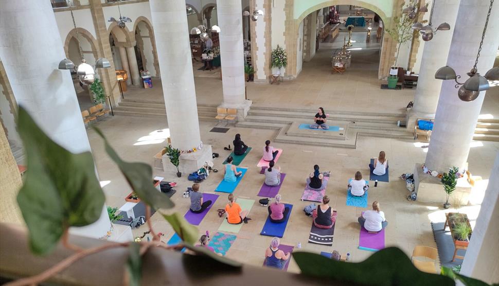 A group of people taking part in a yoga class at Portsmouth Cathedral.