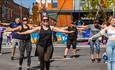 A group takes part in an exercise class in the sunshine at Sweat Festival