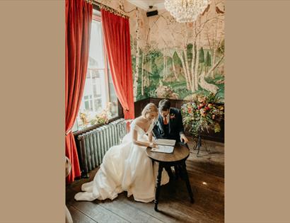man and wife signing register after getting married