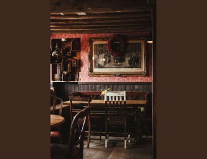 an ambient room with old paintings and a table