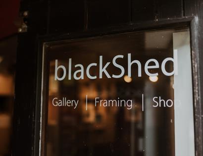 Entrance sign for BlackShed Gallery, framing studio and shop in Robertsbridge.
