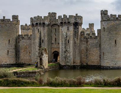 Bodiam Castle surrounded by its moat, showcasing towers, battlements and the historic gatehouse.