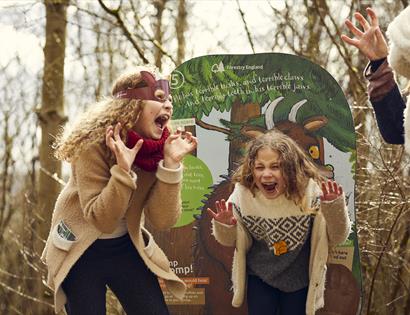 Two children roaring like a gruffalo in the woods. For an even at Bedgebury Pinetum.