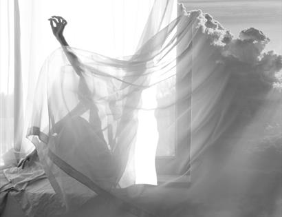 black and white photograph with sheets and clouds