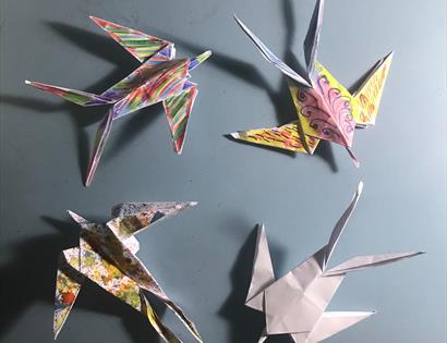 A photograph of four origami birds.