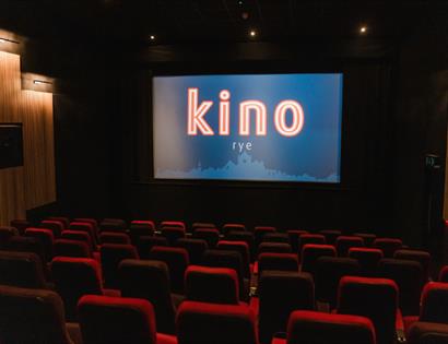 Interior of Kino Rye cinema with plush seating and large screen in a modern auditorium.