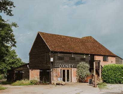 Historic barn at Oxney Organic Estate, home to the vineyard's tasting and visitor experience.