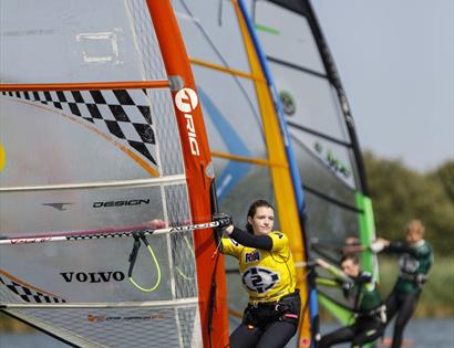 three windsurfers on the water