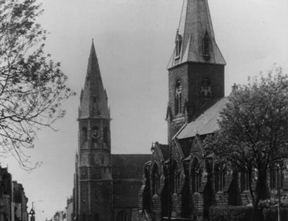 black and white photograph of two churches with spires