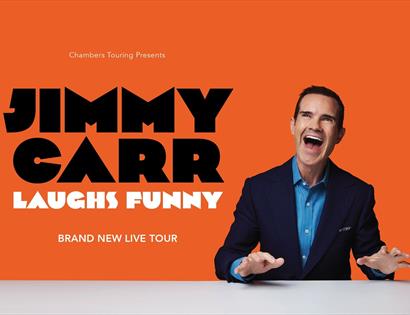 Jimmy Carr on an orange background
