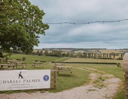 Entrance to Charles Palmer Vineyards overlooking rolling Sussex vineyards, picnic tables and countryside views.