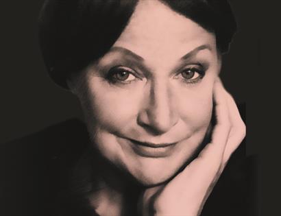 a sepia toned close-up portrait of a woman's face. a white woman with dark hair rests her head on her left hand and looks directly at the camera with