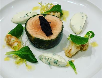 fish dish served on a plate.