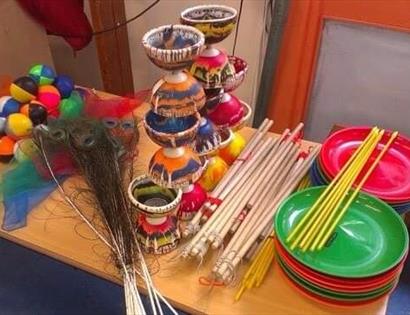 table full of circus items including spinning plates sticks juggling balls and diablo
