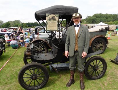 vintage early 20th century car and man in Edwardian style suit.