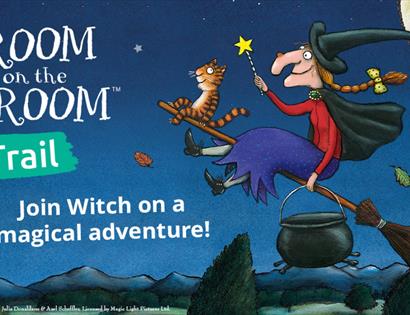 Illustrated witch flying on a broomstick with animals at night under the moon, promoting the Room on the Broom trail.