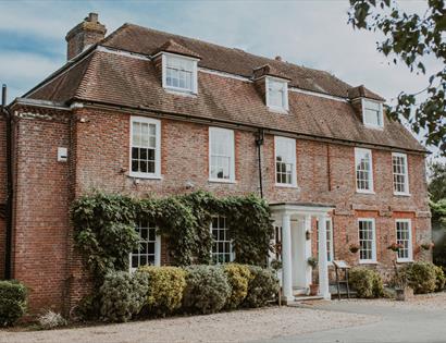 Flackley Ash Hotel near Rye, a large red-brick Georgian-style building with ivy and white entrance columns