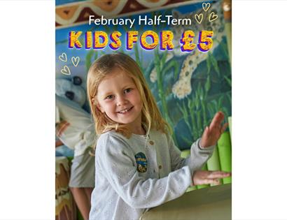Child enjoying a hands-on activity indoors beneath “February Half-Term - Kids for £5” promotional text and playful graphics.
