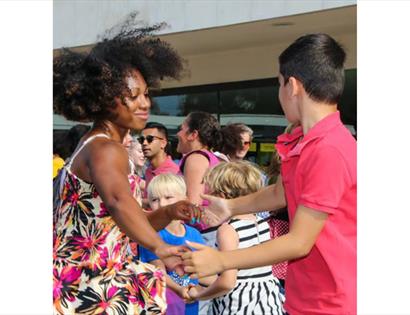 People of different ages dancing together outside the De La Warr Pavilion at the “Let’s Move and Dance Through the Decades” event.