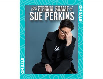 Poster for “The Eternal Shame of Sue Perkins” with seated figure in black suit against blue background, head in hand.