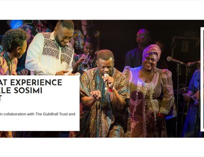 Afrobeat band performing on stage with vibrant traditional clothing and microphones at White Rock Hastings.