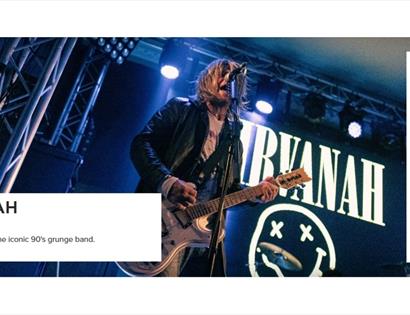 Live performance image for Nirvanah (tribute) at White Rock Theatre, showing a guitarist singing on stage