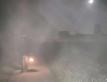 Foggy night scene at Pevensey with a costumed figure holding a lantern during Talking History event.