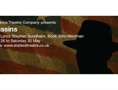 Poster for Assassins by Stephen Sondheim, showing a silhouetted figure in a hat against a faded American flag background.
