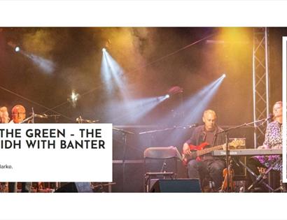 Musicians performing on a lit stage with text promoting ‘Jack in the Green – The Big Ceilidh with Banter’ at White Rock
