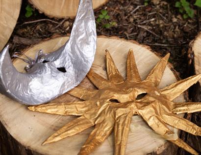 Gold sun and silver moon masks created during a family mask-making workshop at Crafted at Powdermills