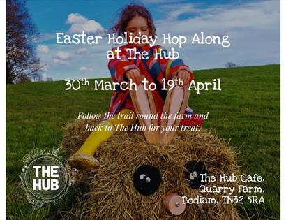 Child sitting on a straw Easter character advertising the Easter Holiday Hop Along at The Hub, Bodiam, 30 March to 19 April.