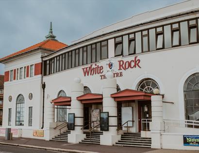 White Rock Theatre entrance on Hastings seafront with distinctive white façade and theatre signage
