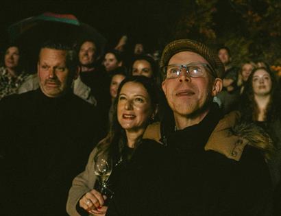 Guests gathered outdoors at night for Bonfire Night celebrations at Crafted at Powdermills.