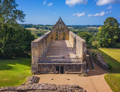 View of Battle Abbey in 1066 Country, with historic stone ruins overlooking the surrounding countryside.