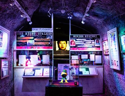 Colourful underground exhibit at Hastings’ True Crime Museum featuring displays on notorious criminal cases.